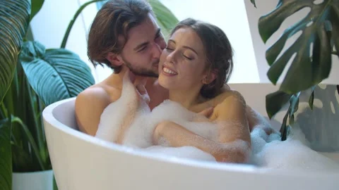 Young couple bathing in the bathroom Stock Footage 147497853