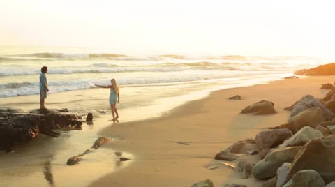 Young Couple on Beach at Sunset - Handheld Shot Stock Footage 25593411