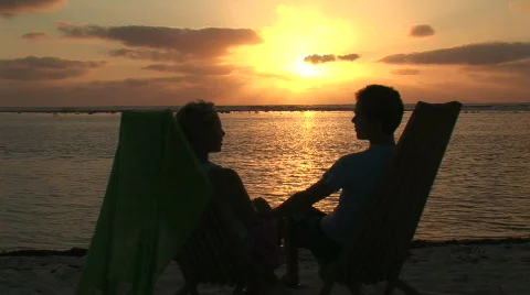 Young Couple on Beach talking Stock Footage 65493