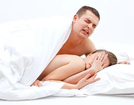 Young couple in bed Stock Photos