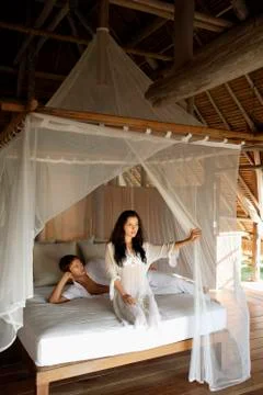 Young couple on bed Stock Photos
