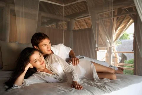 Young couple on bed Stock Photos