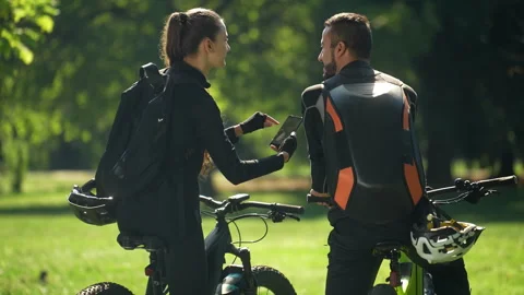 Young Couple on Bicycles Using Navigation App in Nature Stock Footage 252397497