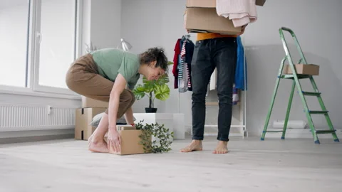 Young couple with boxes moving in new flat, new home and relocation concept. Stock Footage 156452528