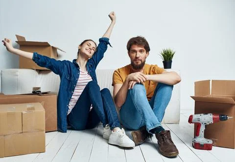 Young couple boxes with things new housing family Stock Photos