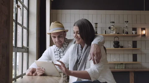 Young couple browzing the internet or online shopping in cafe. Steadicam shot Stock Footage 199632256