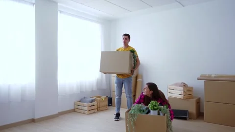 Young couple carrying cardboard boxes to new house Stock Footage 244640887