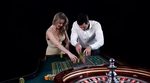 Young couple celebrating win at roulette table in casino. Black Stock Footage 61175480