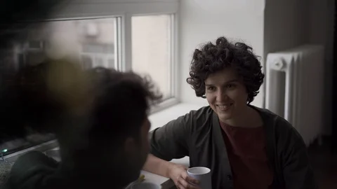 A young couple chatting cheerfully by the window next to the green Christmas  Stock Footage 118546928