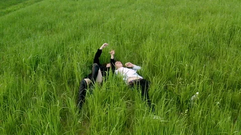 Young couple chatting lying on the grass Stock Footage 206405004