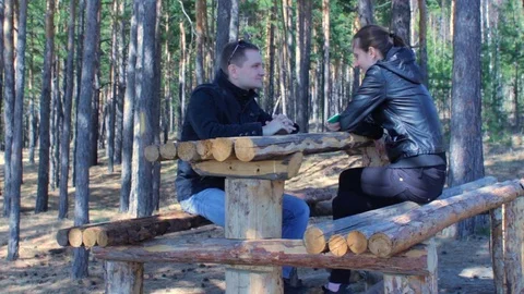 Young couple chatting smiling having rest in beautiful autumn forest Stock Footage 75671810