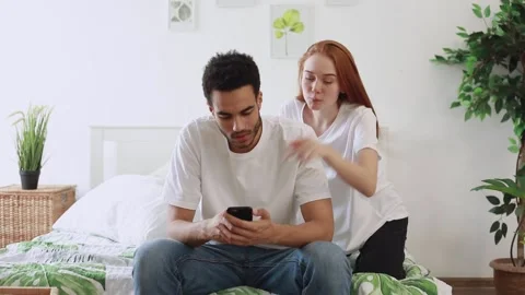 Young couple checking social media and news on smartphone. Stock Footage 181537896