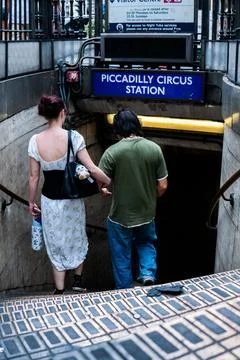 Young couple checking subway map at Piccadilly Circus station entrance in London Fotos Stock
