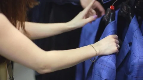 Young couple choose a jacket in the store Video stock 75879591