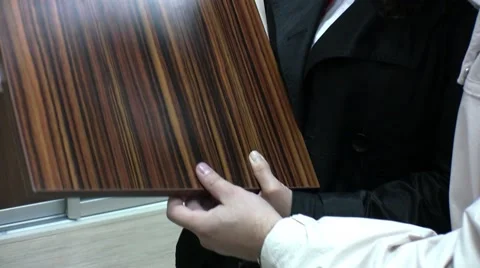 Young couple choosing materials for their new wardrobe. Stockbeeldmateriaal 57216343