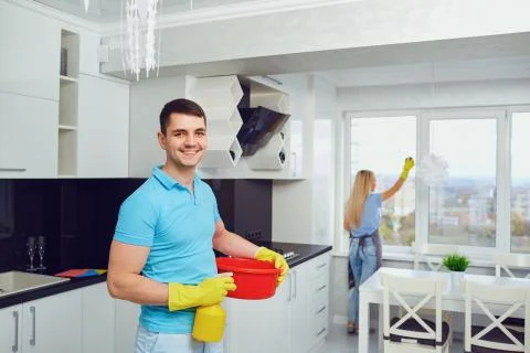 A young couple is cleaning an apartment. Stock Photos