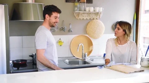Young couple cleaning kitchen after having dinner Stock Footage 74729728