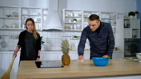 Young couple cleans the kitchen Stock Footage 127288718