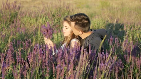 Young couple in the colors of the spring field Stock Footage 89258446