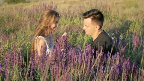 Young couple in the colors of the spring field Stock Footage 89259552