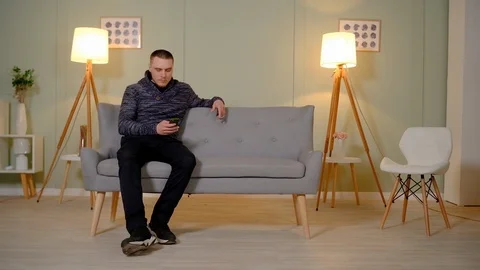 Young couple communicates sitting on a sofa Stock-Footage 126899418