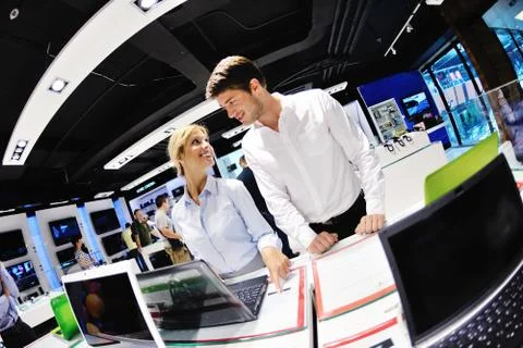 Young couple in consumer electronics store Stock Photos
