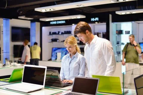 Young couple in consumer electronics store Stock Photos