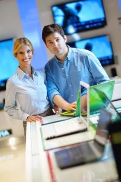 Young couple in consumer electronics store Stock Photos