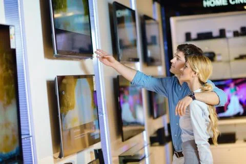 Young couple in consumer electronics store Stock Photos