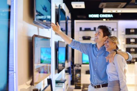 Young couple in consumer electronics store Stock Photos