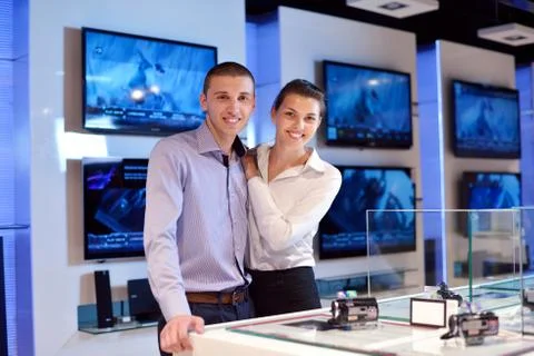 Young couple in consumer electronics store Stock Photos