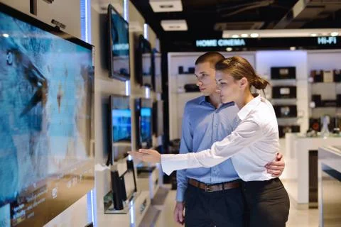 Young couple in consumer electronics store Stock Photos