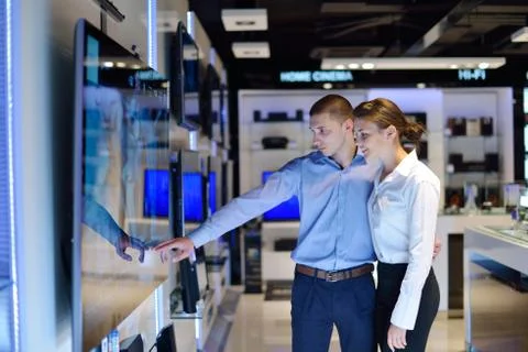 Young couple in consumer electronics store Stock Photos