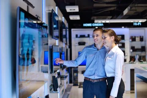 Young couple in consumer electronics store Stock Photos
