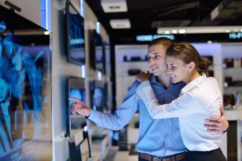 Young couple in consumer electronics store Stock Photos