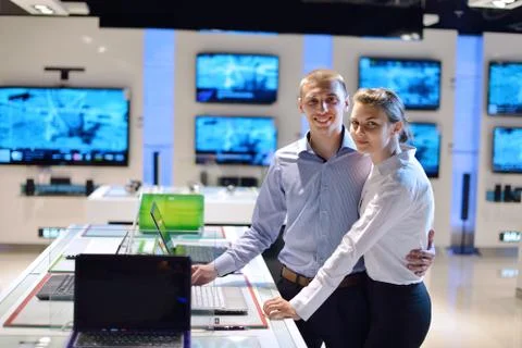 Young couple in consumer electronics store Stock Photos