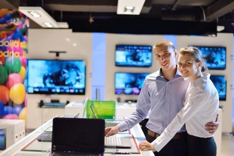 Young couple in consumer electronics store Stock Photos