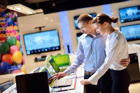 Young couple in consumer electronics store Stock Photos