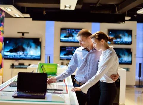 Young couple in consumer electronics store Stock Photos