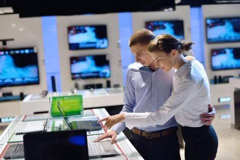 Young couple in consumer electronics store Stock Photos