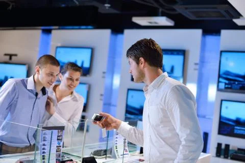 Young couple in consumer electronics store Stock Photos