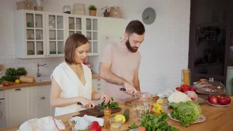 Young couple cooking together in kitchen at home Stock Footage 146277953