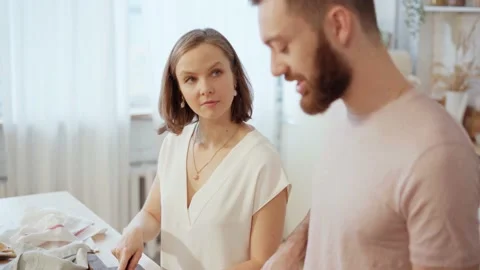 Young couple cooking together preparing dinner and talking at home Stock Footage 146278057