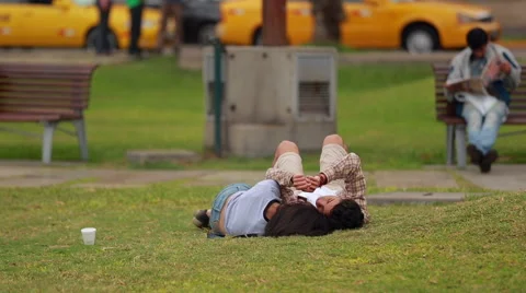 Young couple cuddling in the park Stock Footage 63906275