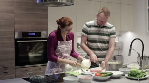 Young couple cut vegetables in the kitchen Stock Footage 58758701
