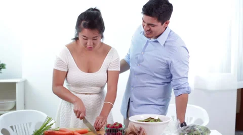 Young Couple Cutting Vegetables and Preparing a Healthy Meal Together Stock Footage 27257235