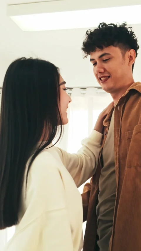 A young couple dances joyfully in a bright room, smiling and enjoying each other Stock-Footage 327695318