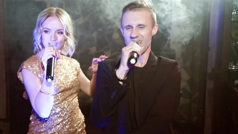 Young couple dancing and singing at a party Stock Footage 105866975