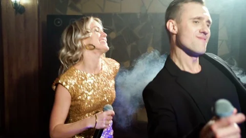 Young couple dancing and singing at a party Stock Footage 108035507