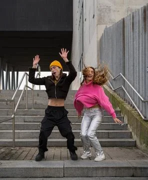Young couple dancing fun on some stairs. Stock Photos